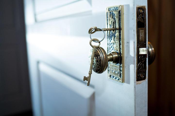 Door with key hanging from door knob